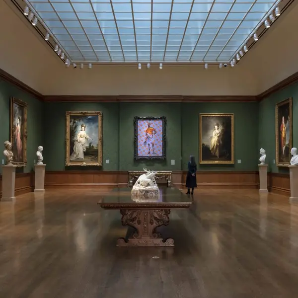 woman in gallery looking at paintings