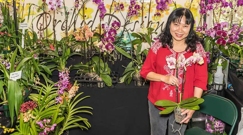 A happy visitor enjoying themselves at the Orchid show and sale.