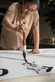 Calligraphy artist Tang Qingnian 唐慶年 at work on a large scroll during a public demonstration in 2018. Tang was the Cheng Family Foundation Artist-in-Residence at The Huntington in 2019. The Huntington Library, Art Museum, and Botanical Gardens. Photo by Jaime Pham