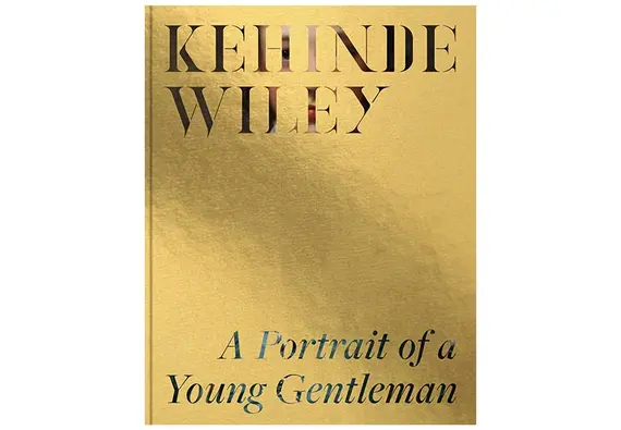 A gold leafed cover with stenciled writing of artist and book title that reveals The Blue Boy painting underneath.