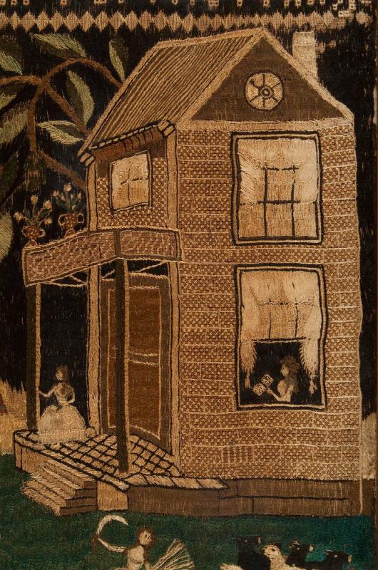 Detail of embroidered image of exterior of brick house with a woman reading in the window.