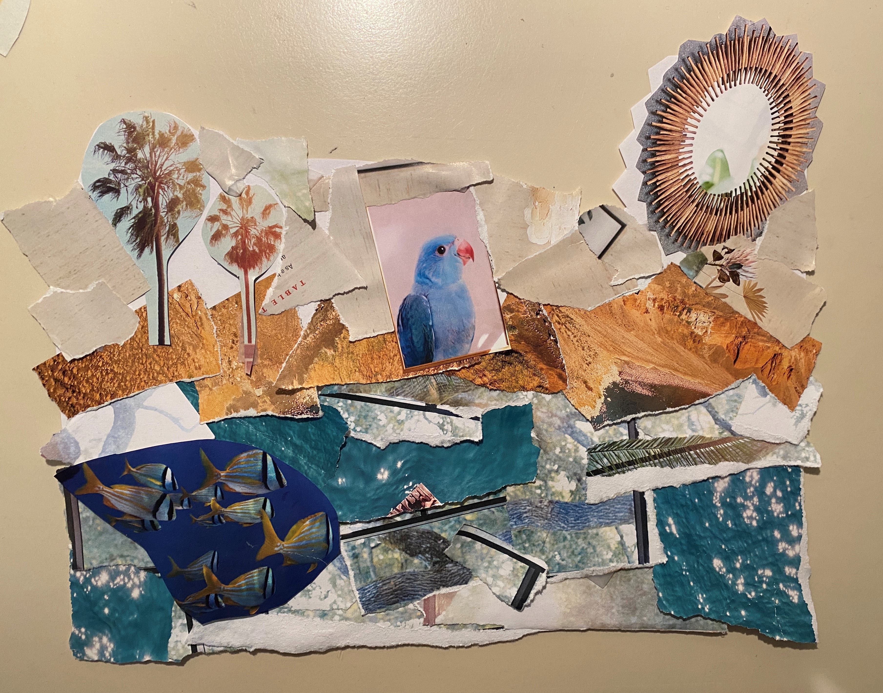 Collage with blue ripped paper near the bottom, tan ripped paper near the middle, and white ripped paper near the top.