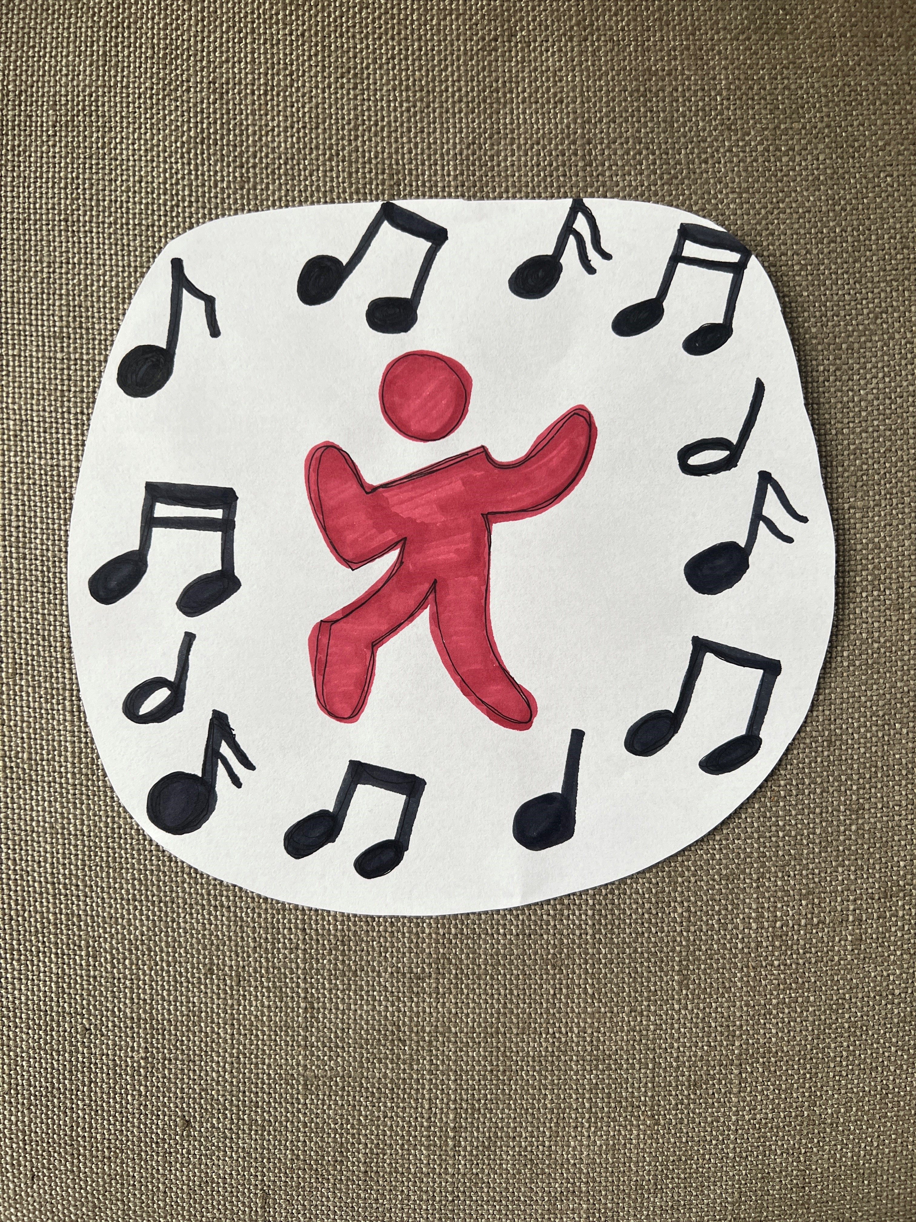 Drawing of a person dancing with musical notes in a surrounding circle.