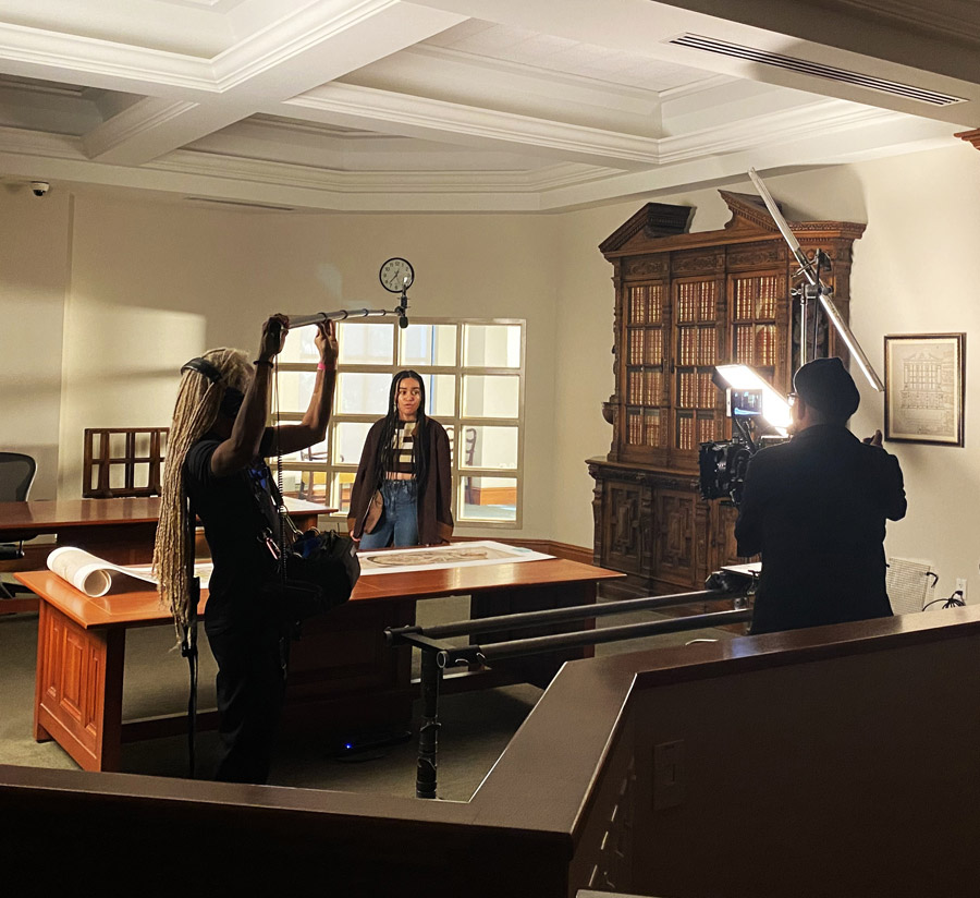 Three GFS participants film a scene in the Ahmanson Reading Room.