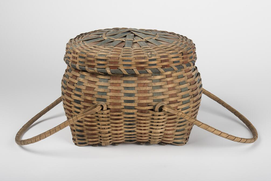 Woven basket with a lid and two handles.