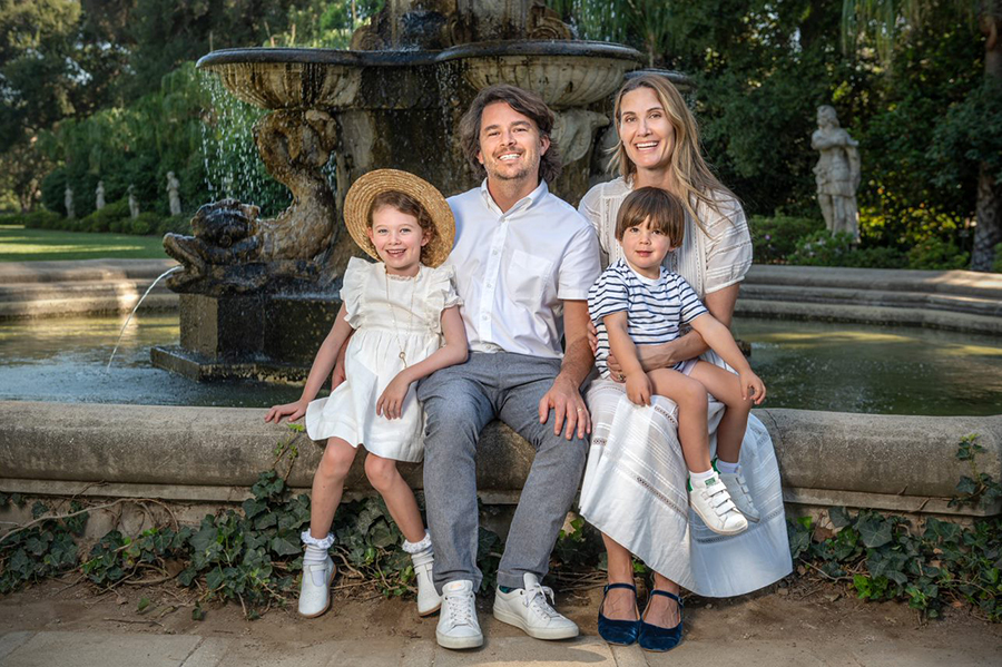 family sitting in front of fountain