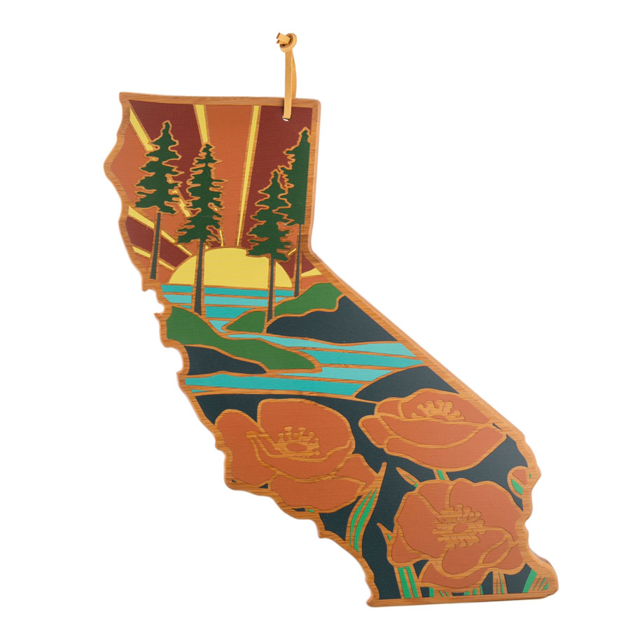 A wooden board in the shape of the state of California, depicting a beach scene.