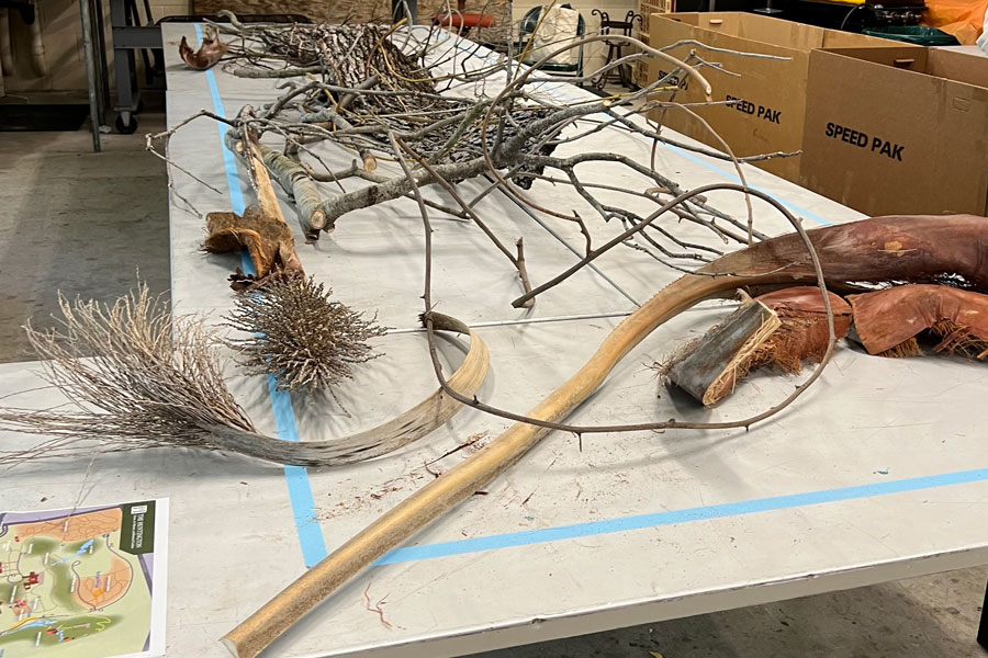 A pile of branches on a table in a workshop.