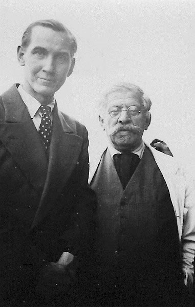 A black-and-white photo of two people looking at the camera.