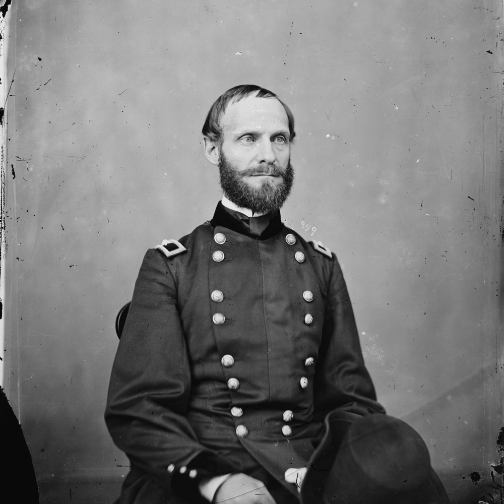 A black-and-white photo of an Army general, seated in uniform.