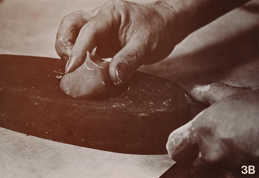Close-up view of a baker’s hands crafting a moon cake.