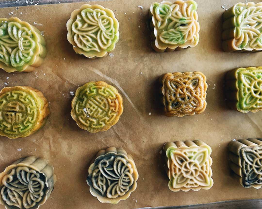 An overhead view of colorful pastries with ornate details.