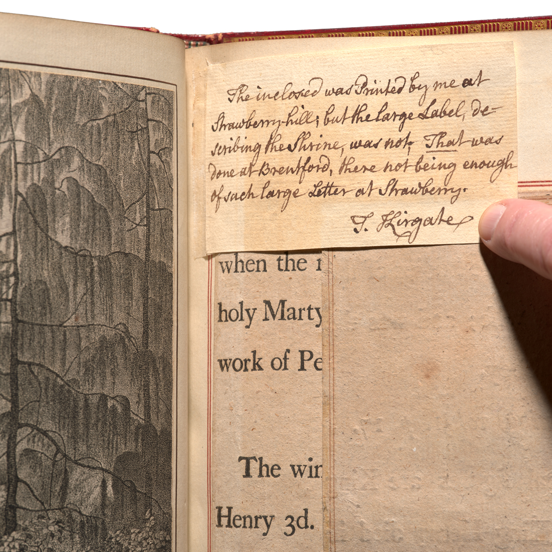 An open book with layers of papers on the same page, including an illustration and printed and handwritten text.