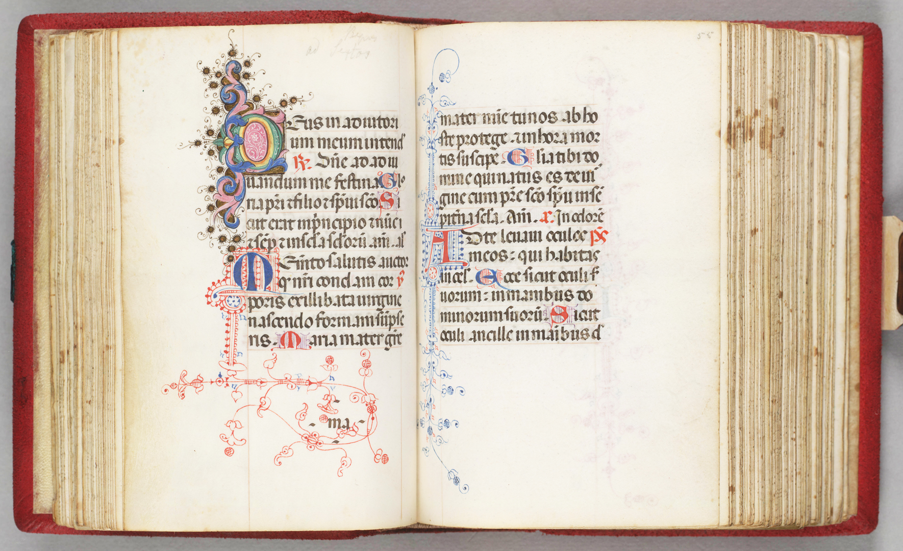 An open book with Italian text, featuring colorful ornate lettering throughout.