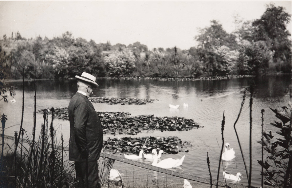 Henry E. Huntington with ducks and swans in the reservoir, circa 1915