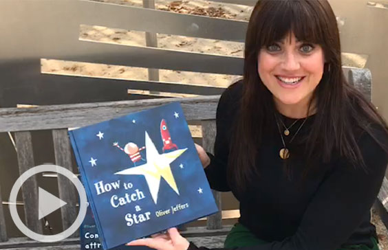 Staff member with To Catch a Star book