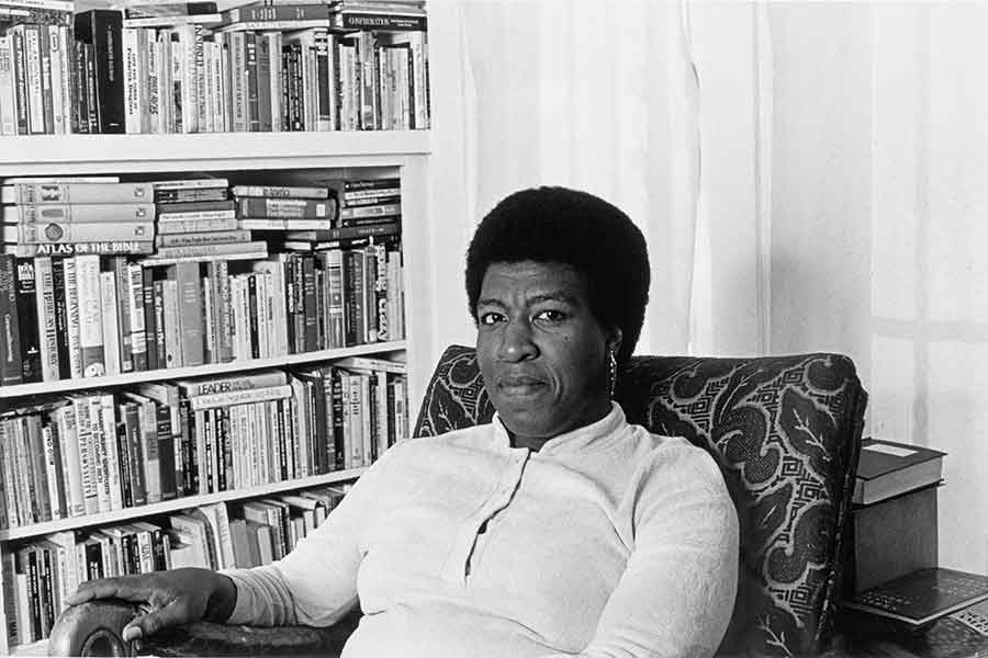 Patti Perret, photograph of Octavia E. Butler seated by her bookcase, 1984. © Patti Perret