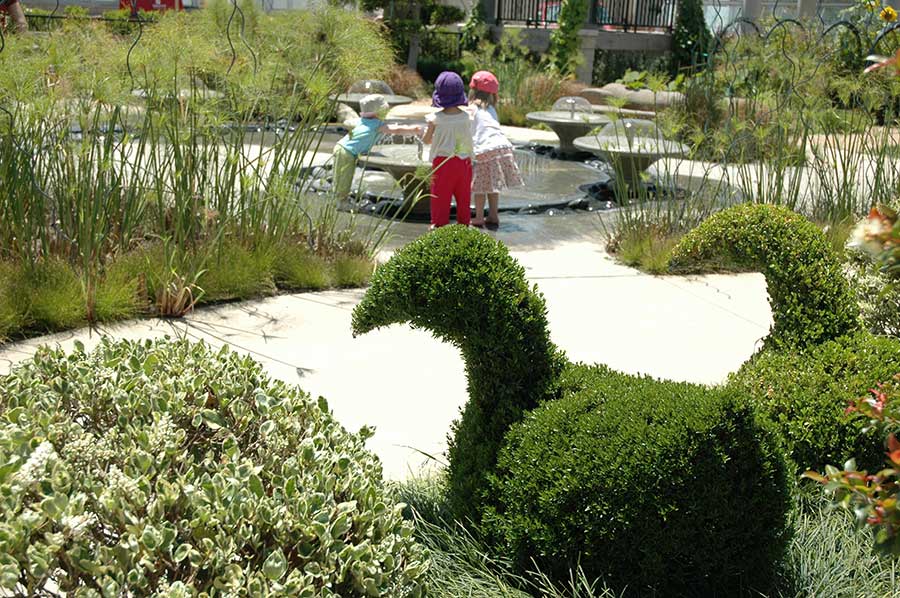 As topiary animals look on, children enjoy the shimmer and splash of toddler-sized fountains in the Helen and Peter Bing Children’s Garden. The Huntington Library, Art Museum, and Botanical Gardens.