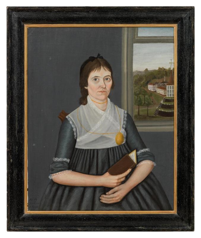 Painting of white woman in voluminous grey dress with white sash and large locket around her neck seated before a window holding a prayer book and looking at the viewer.  