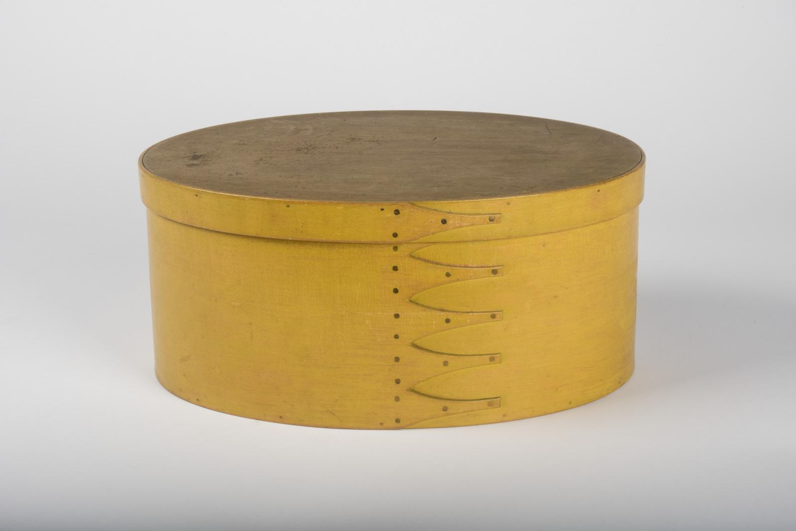Large, oval, pine and maple box, smooth and plain with six fingers forming a side seam and a chrome yellow finish.