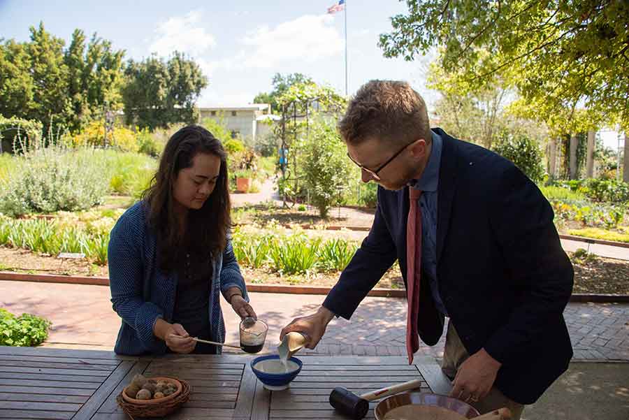 Kelly Fernandez, head gardener of the Herb and Shakespeare gardens, and Joel Klein, Molina Curator for the History of Medicine and Allied Sciences, make iron gall ink, using a recipe from the 1600s. Photo by Deborah Miller.