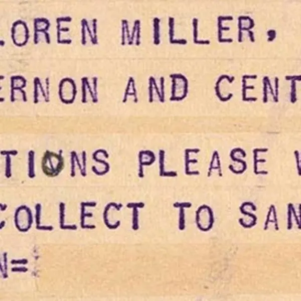 Part of a Western Union telegram has typed purple letters in all caps.