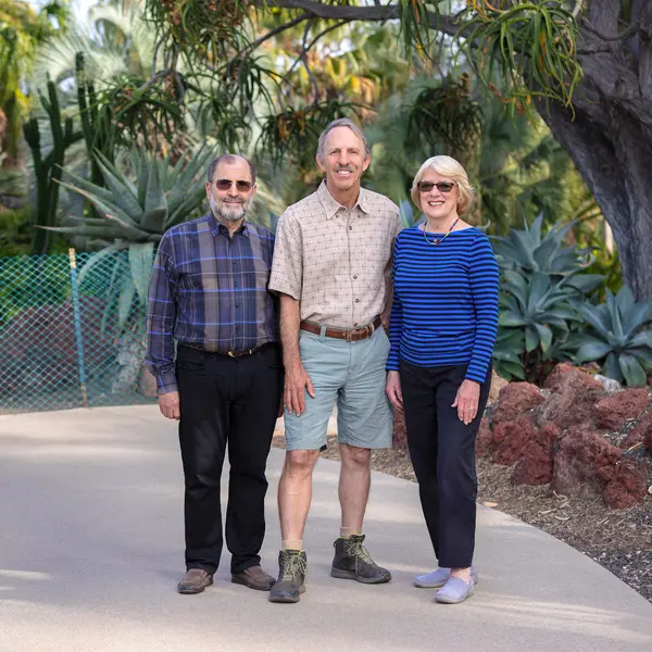 Three people stand at the entrance to the Desert Garden.
