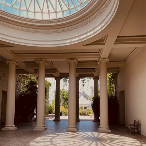 A photo of a breezeway with columns and a glass dome.