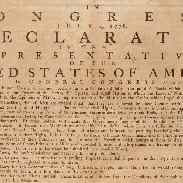 A tan paper with a title in large font that reads, “In Congress, July 4, 1776, a declaration by the representatives of the United States of America, in General Congress assembled.”