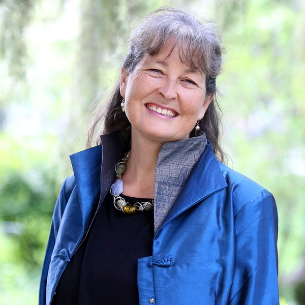 Jeannine Cavender-Bares in blue blazer smiles at camera.