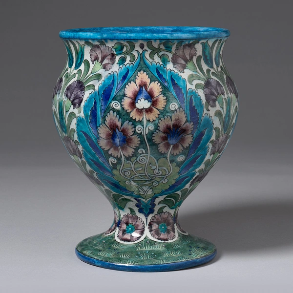 A ceramic vase with a multicolored, stylized botanical motif.