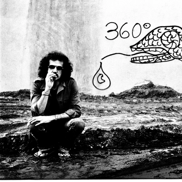 Grayscale image of a person squating on a dirt patch in front of a white wall with graffiti of a stylized fish and "360º."