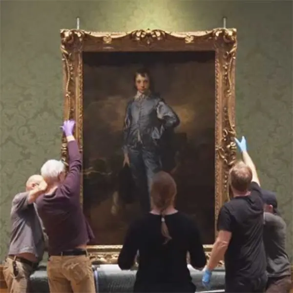 staff removing painting of The Blue Boy from the gallery wall