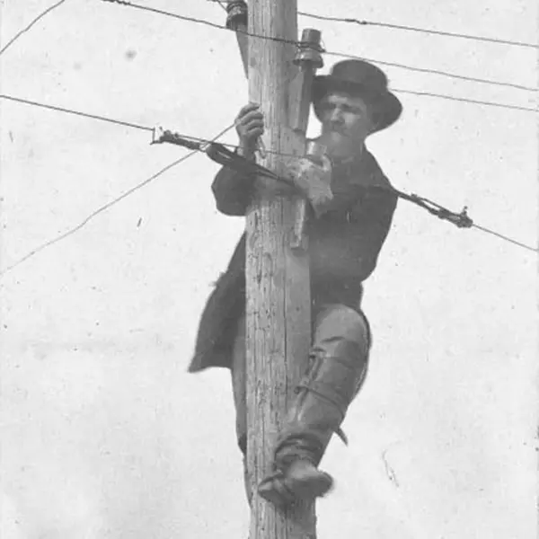 Man on a pole repairing telegraph