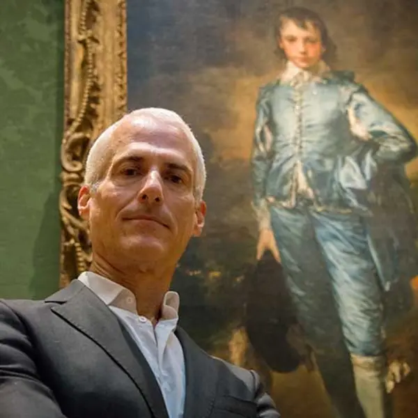 man standing in front of blue boy painting