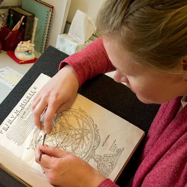 Woman doing conservation on a book