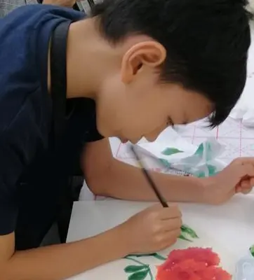 Child painting with a brush