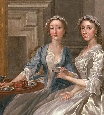 Two people in formal dresses sit near a small table with tea service.