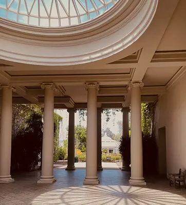 A photo of a breezeway with columns and a glass dome.