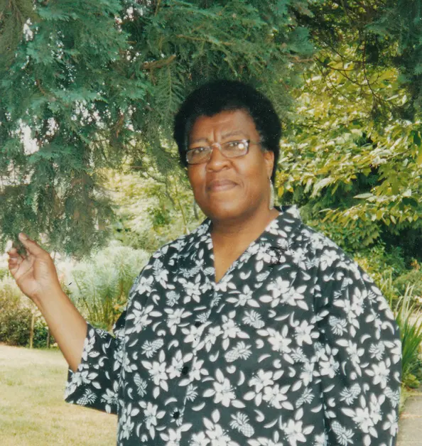 Octavia E. Butler standing by a tree