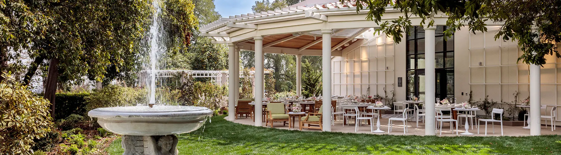 An outdoor tea room seating area and a fountain.