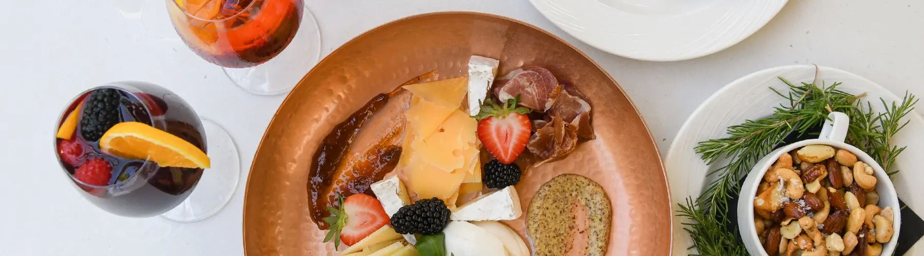 An overhead view of a table with various plates of food and drinks.