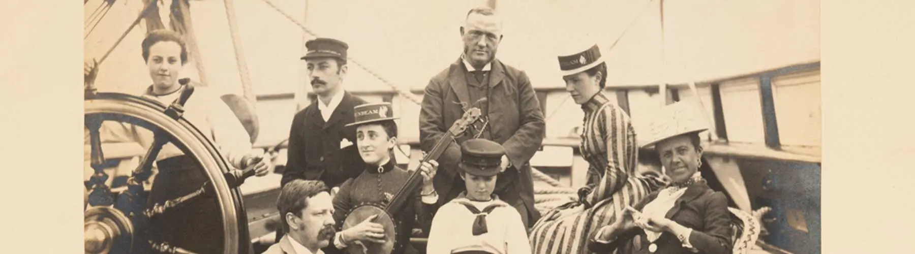 b/w photo of men and women on a ship deck with a banjo