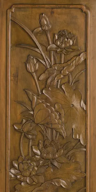 Woodcarving of lotuses with the flowers growing upward.
