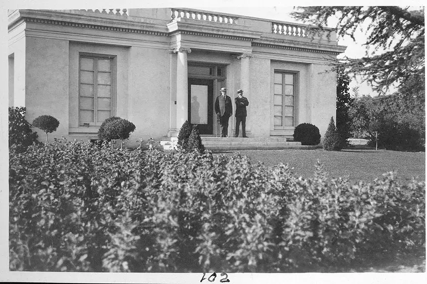 Henry E. Huntington and his personal secretary, Robert Varnum, in front of the, at the time, billiard building (now the tea room) on the Huntington grounds, circa 1915.