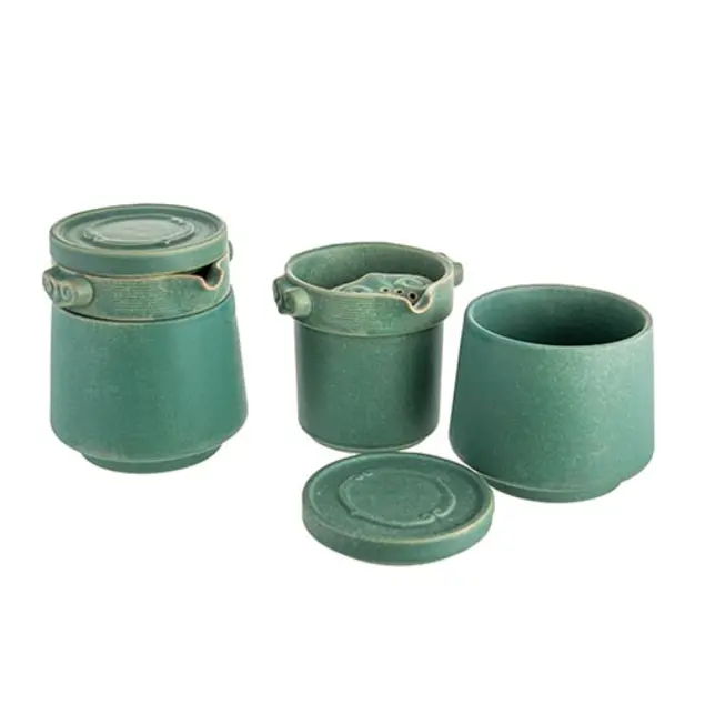 A 4-piece seafoam green colored ceramic tea set.