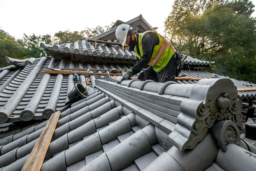 An artisan works on the roof tiles of The Huntington’s Japanese Heritage Shōya House. 