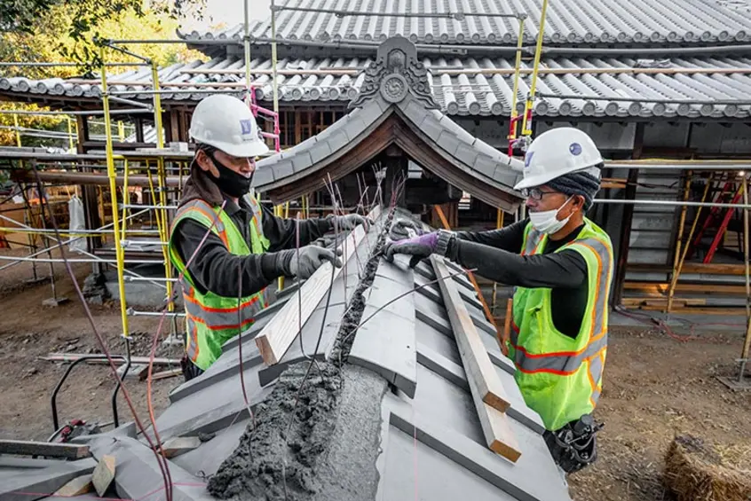 Artisans work on the roof tiles of The Huntington’s Japanese Heritage Shōya House. 