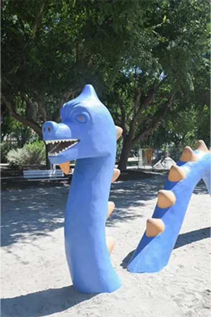 A smiling blue sea serpent at a playground.