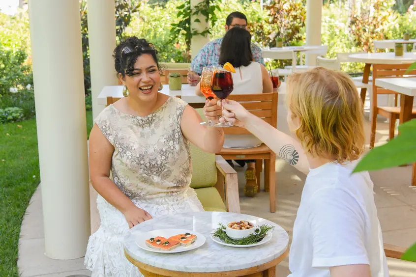 People sit at tables in an outdoor restaurant.